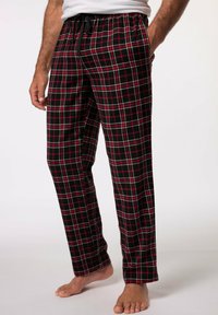 Pantalones de pijama a cuadros rojos y negros, hechos de tela suave, con una cinturilla elástica con cordón y bolsillos laterales.