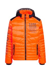 Padded jacket in bright orange with black accents. Features zippered front and pockets, logo prints on sleeves and chest. Quilted texture.
