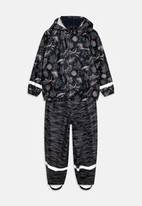 Rain suit featuring a dark navy background with beige marine life patterns. Includes a hood and reflective accents on sleeves and legs.