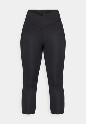 Leggings capri neri realizzati in tessuto elasticizzato. Presentano una vita alta con un design incrociato e dettagli delle cuciture sottili lungo le gambe.