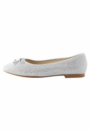 White ballet flat shoe with small rhinestones, a bow on the rounded toe, and a flat tan sole.