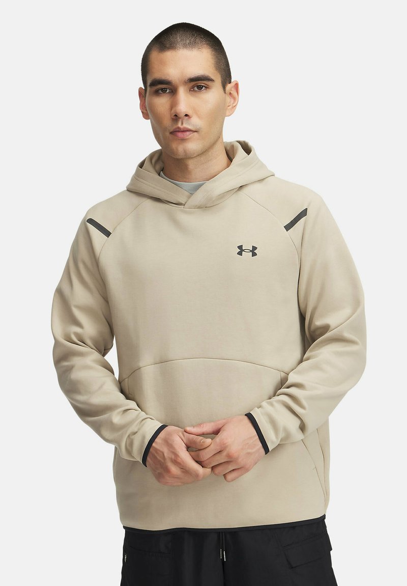 Sudadera beige con bolsillo canguro, acentos negros y capucha con cordón. Presenta una textura suave y un diseño ajustado.