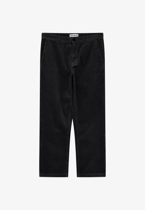 Black corduroy pants with a loose fit, featuring side pockets and a waistband with a button closure. Texture is ridged and soft.