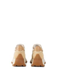 Light tan and cream suede sneakers with a thick white rubber sole, featuring textured overlays and a cushioned collar.