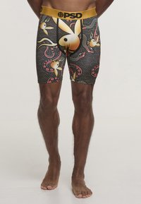 Boxer neri con motivi colorati di pesci e onde. Vita elastica dorata con logo "PSD". Tessuto morbido con design aderente.