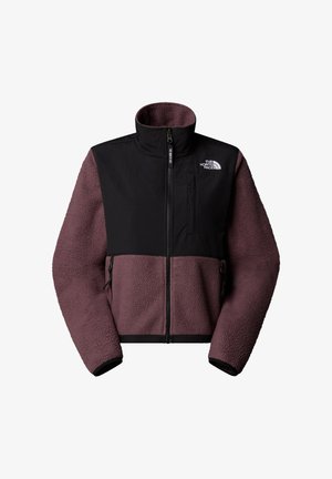 Fleece- und Nylonjacke mit schwarzem oberen und lila unterem Teil, ausgestattet mit einem hohen Kragen, einem Reißverschluss vorne und Seitentaschen.