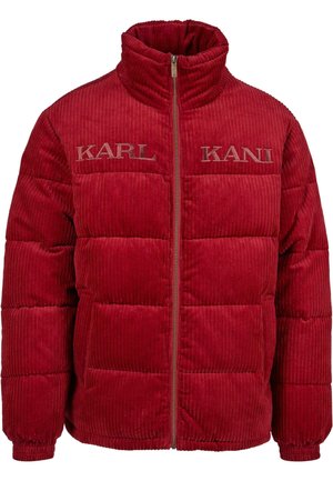 Red corduroy puffer jacket with a high collar, featuring horizontal quilted sections and embroidered "KARL" logos on the chest. Zipper closure.
