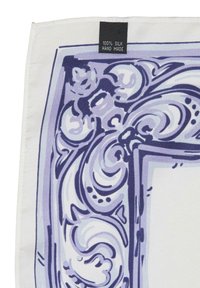 Silk scarf featuring a white background with purple ornamental patterns. Edge is neatly hemmed; tag reads "100% SILK HAND MADE."