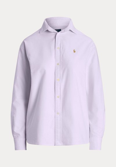 Light purple long-sleeve button-up shirt made of cotton. Features a pointed collar, front buttons, and a small embroidered logo on the chest.