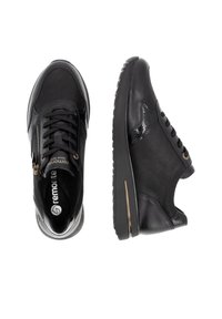 Black sneakers with a mix of matte and glossy materials, featuring a lace-up design, side zipper, and a cushioned sole with gold accents.