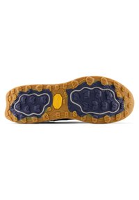 Suela de zapato con surcos de goma amarillo profundo y azul oscuro diseñados para agarre, con el logo hexagonal de Vibram en el centro.