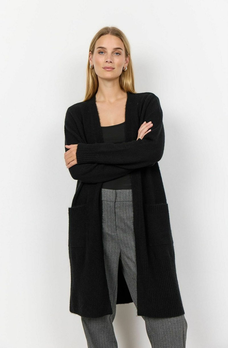 Long black cardigan made of soft material, featuring a ribbed texture, open front, and two front pockets. Simple, versatile design.