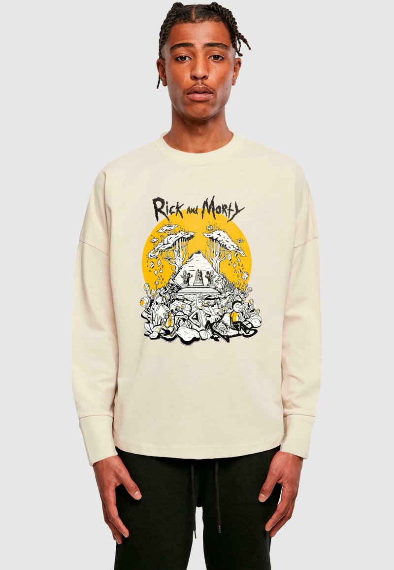 Cremfarbener Sweatshirt mit einem grafischen Design aus "Rick and Morty", das einen gelben Kreis, komplexe Illustrationen und schwarze Akzente aufweist.