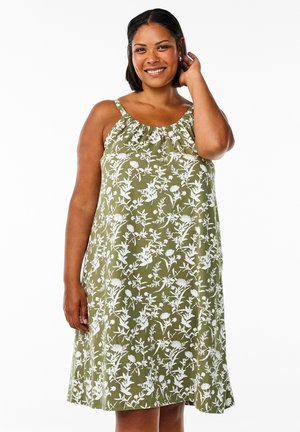 Ärmlös grön klänning med vitt blommönster, rynkad halsringning och A-linjeformad silhuett, gjord av lätt tyg.
