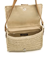 Borsa in paglia intrecciata color sabbia con un interno beige liscio. È dotata di chiusura magnetica e tasca con zip, progettata per funzionalità e organizzazione.