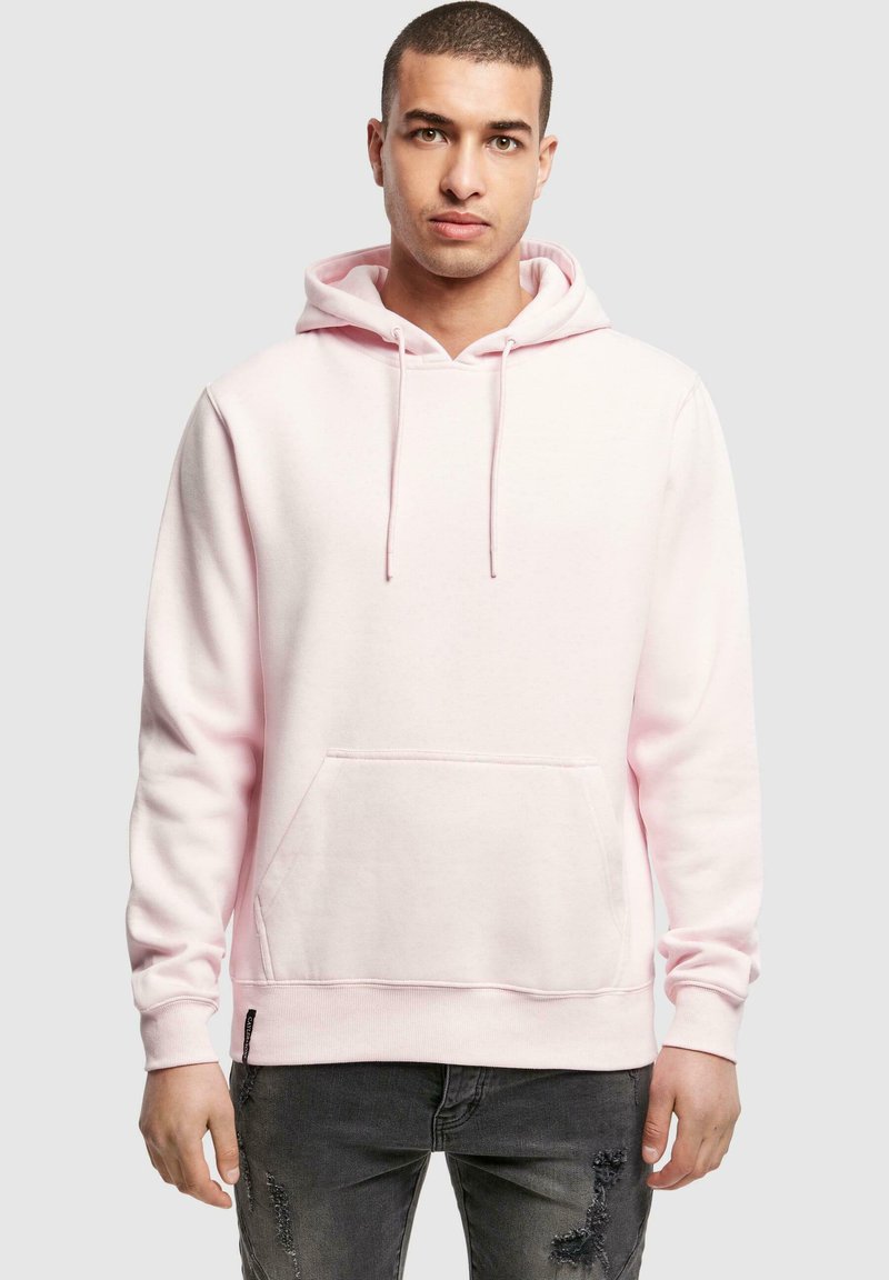 Light pink hoodie made of soft fabric, featuring a kangaroo pocket and drawstring hood. Standard fit with ribbed cuffs and hem.