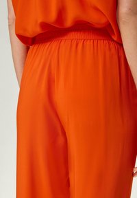 s.Oliver Tracksuit bottoms - dunkelorange