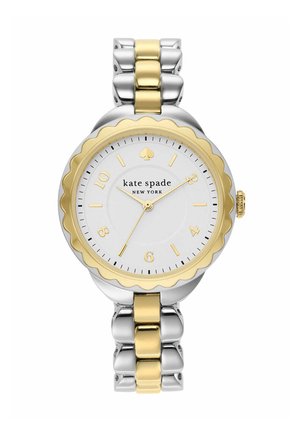 Tofarvet sølv- og guldkate Spade New York armbåndsur med bølget guldring og hvid urskive, der viser kl. 10:34:11.
