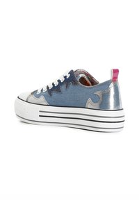 Denim sneaker with silver accents, white rubber sole, and black horizontal stripes. Features a rounded toe and lace-up design.