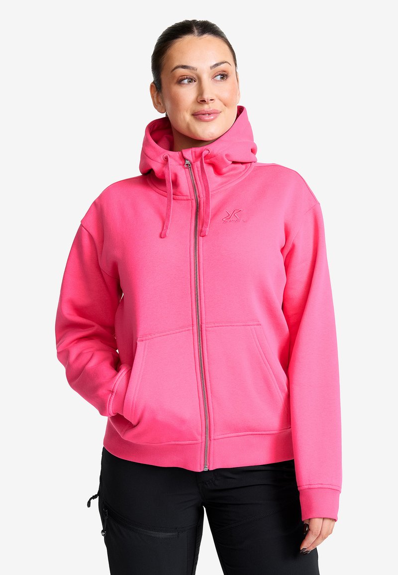 Rosa zip-up hoodie med en stor huva, framfickor och ribbade muddar. Har en liten logotyp på bröstet och är tillverkad av mjukt tyg.