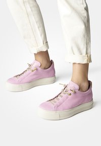 Rosa Wildlederschuhe mit einer strukturierten Oberseite, crèmefarbener Gummisohle und kontrastierenden Schnürsenkeln. Verfügt über eine Zuglasche an der Ferse und goldene Hardware-Details.