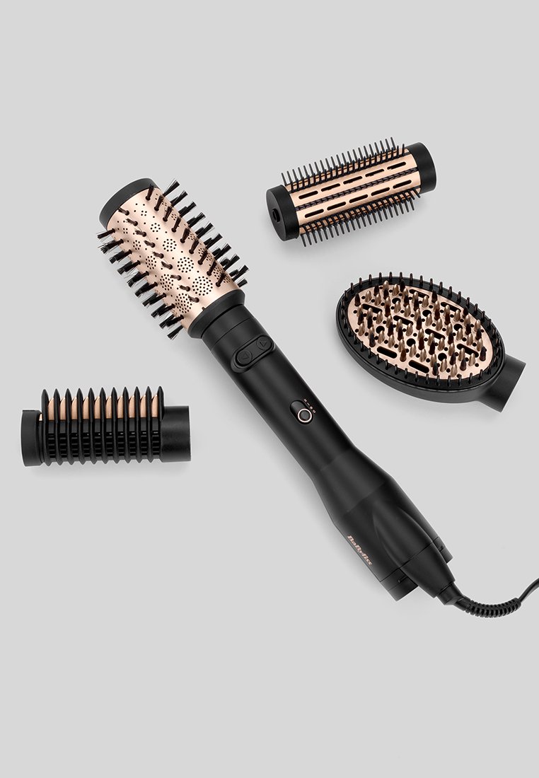Brosse sèche-cheveux noire avec des accents en or rose, offrant plusieurs têtes interchangeables : brosses rondes, ovales et plates avec différents designs de poils.