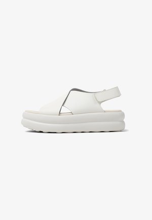 White platform sandals made of smooth leather, featuring an open toe, cross-over design, and an adjustable strap at the heel.