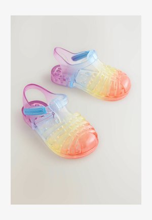 Prozorne gumene sandale z gradientnim dizajnom od vijolične do roza, s teksturirano površino in odprtim prstom.