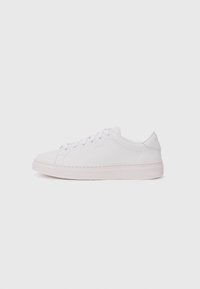 Sneaker bianco con tomaia in pelle liscia, punta rotonda e suola piatta in gomma. Presenta chiusura con lacci e un logo discreto di lato.