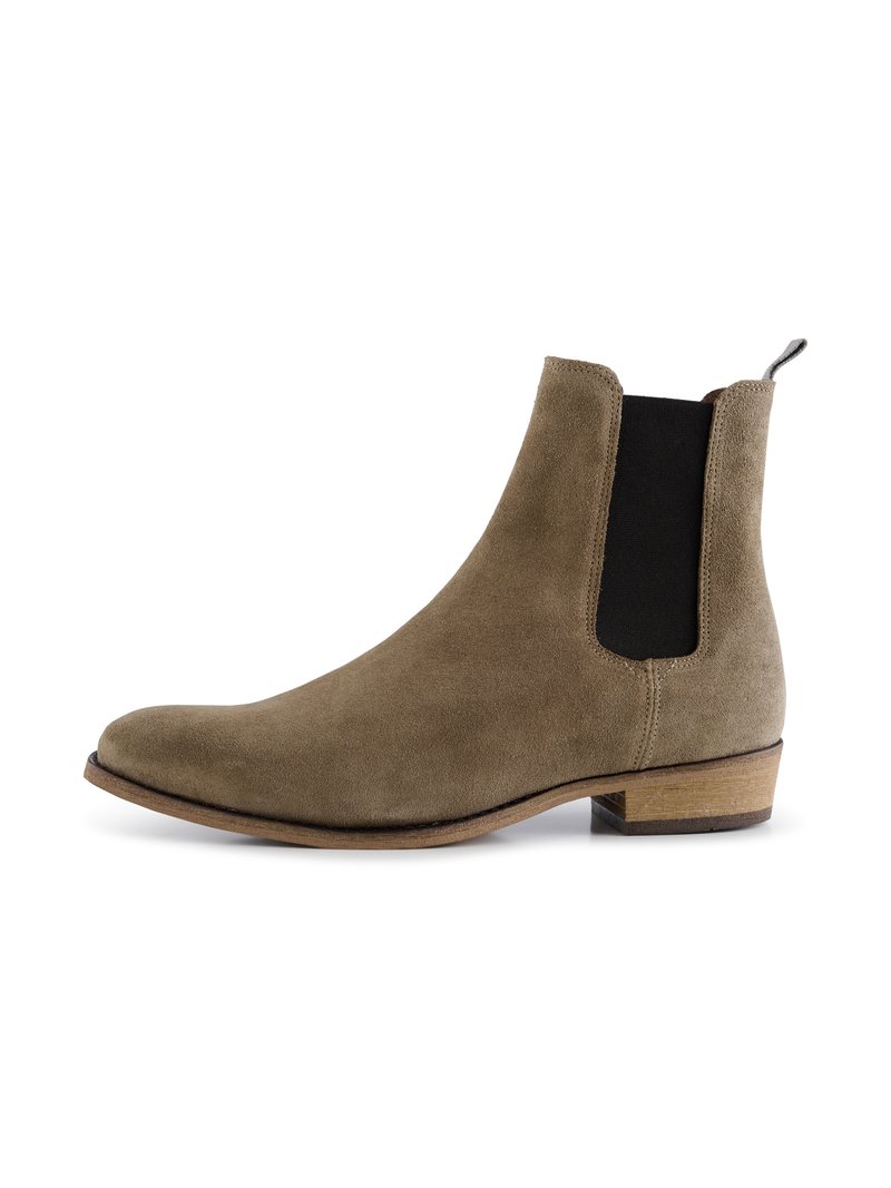 Bruna mockaskinnankleboots med elastiska sidopaneler, spetsig tå och låg träklack. Slät textur med minimalistiska design detaljer.