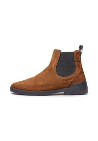 Bottines Chelsea en daim marron avec un élastique noir, forme épurée et semelle en caoutchouc texturé pour plus d'adhérence.