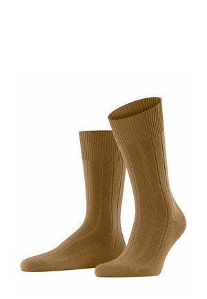 Braune, gerippte Socken in Knöchelhöhe mit einer strukturierten Oberfläche sowie verstärktem Zehen- und Fersenbereich für zusätzliche Haltbarkeit.