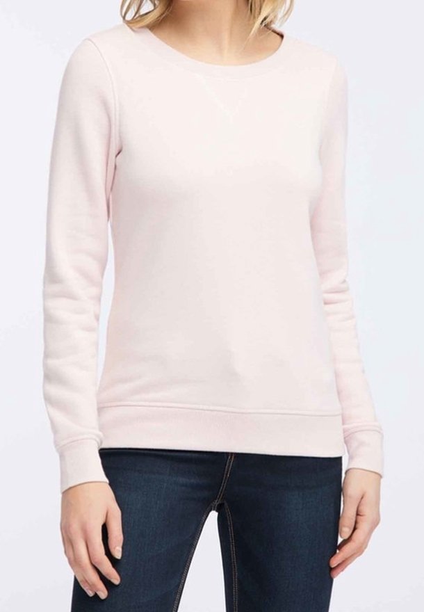 Sweatshirt rose clair à manches longues, col rond, poignets et ourlet côtelés. Confectionné dans un tissu doux avec une texture lisse.