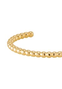 Bracelet en métal doré avec des perles sphériques, texture lisse et un design flexible et ouvert pour un ajustement réglable.