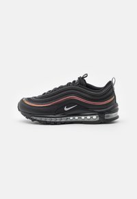 Black Nike Air Max 97 sneaker with wave-like design, accented with red and orange stripes, featuring a visible air unit and rubber outsole.
