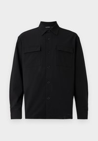 Mustast siledast kangast must pikkade varrukatega särk, millel on klassikaline krae, ees nööbid ja kaks rinnataskut. Lihtne disain ilma mustriteta.