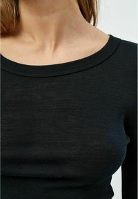 Schwarzer gerippter Strickoberteil mit weitem Ausschnitt und taillierter Silhouette, das eine weiche Textur und ein glattes Finish zeigt.
