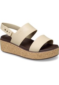 Sandalias de plataforma color crema con suela de corcho, dos correas anchas y una correa trasera para soporte. Plantilla texturizada para mayor comodidad.