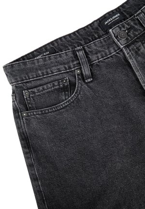 Czarne luźne dżinsy z pięcioma kieszeniami, z zapięciem na guzik i charakterystycznym logo na pasku. Teksturowana tkanina dżinsowa z lekko wyblakłym wykończeniem.