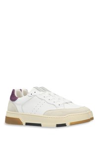White sneakers with a textured grey suede toe, purple heel accent, and beige rubber sole featuring black details. Lace-up design with perforations.