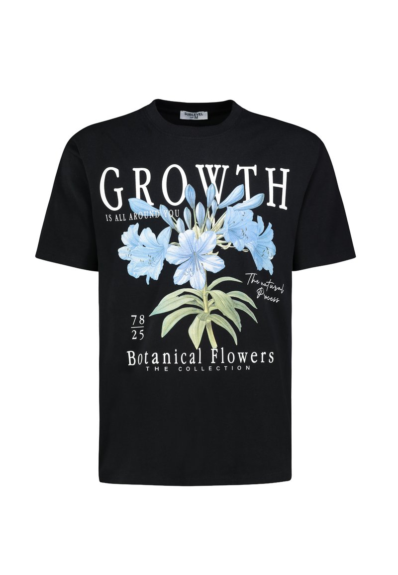 Black cotton t-shirt featuring a front graphic of blue flowers, text reading "GROWTH IS ALL AROUND YOU," and design elements like botanical details.