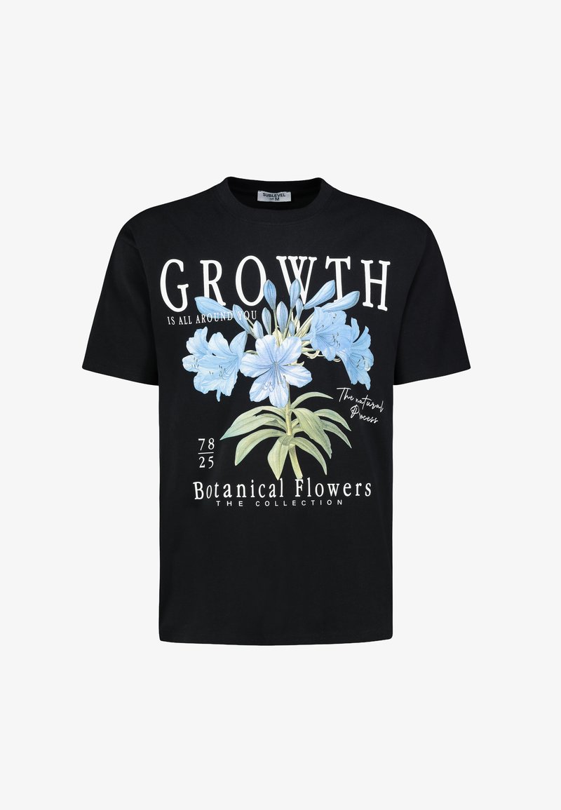 Black cotton t-shirt featuring a front graphic of blue flowers, text reading "GROWTH IS ALL AROUND YOU," and design elements like botanical details.