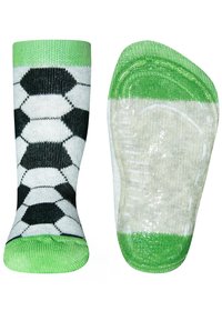 Fußballsocken mit einem hexagonalen schwarz-weißen Muster, einem grünen Bündchen und einer grünen Sohle, aus einem weichen, dehnbaren Material.