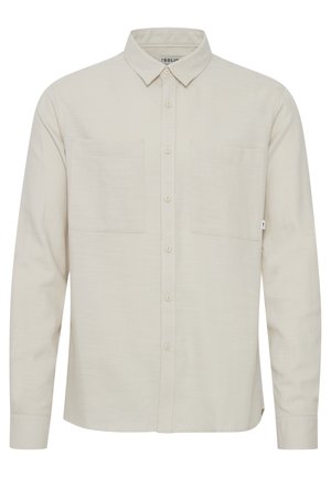 Lichtbeige lange mouw shirt in een gestructureerde stof, met een spread collar, twee borstzakken en knoopsluiting aan de voorkant.