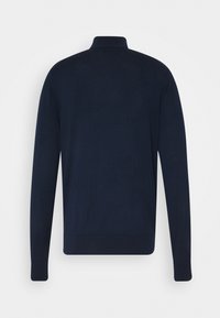 Mörkblå stickad tröja med hög krage och långa ärmar. Har en jämn textur samt ribbade muddarna och nederkanten för en åtsittande look.