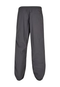 Dunkelgraue, lockere Hose mit elastischem Bund und Kn�öchelbündchen, ausgestattet mit einer einzelnen Gesäßtasche auf der rechten Seite.