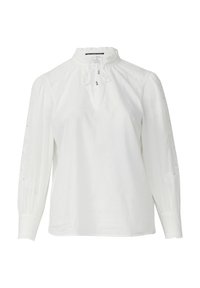 Chemisier blanc à col montant et détails à cordon. Il présente des manches longues avec des motifs floraux brodés et des poignets froncés.