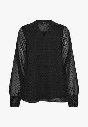 Blouse noire transparente à manches longues avec pois texturés, col en V et poignets élastiqués, tissu semi-transparent sur les manches et le haut de la poitrine.