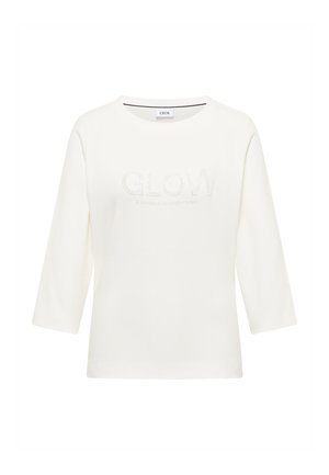 Camisetta bianca a tre quarti con testo "GLOW" e dettagli scintillanti. Tessuto morbido con scollatura tonda e vestibilità rilassata.