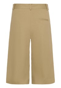 Shorts beige arrivant aux genoux avec passants pour ceinture et une poche passepoilée unique à l'arrière du côté droit.